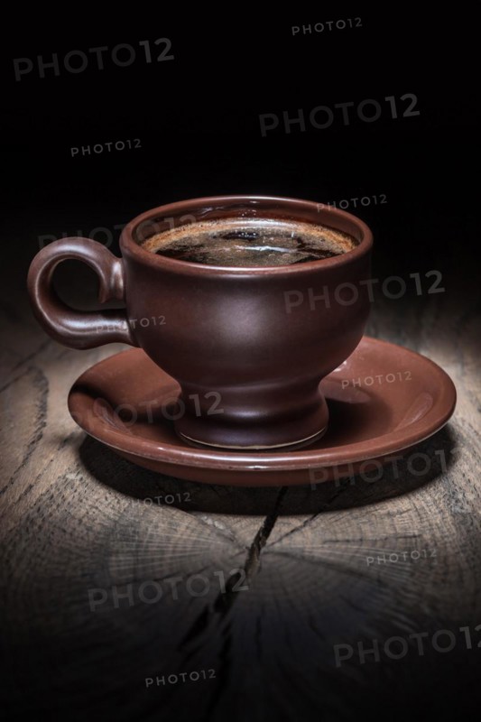 Brown clay coffee cup on vintage wood
