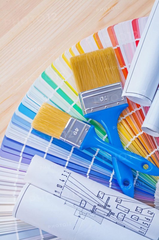 Blue prints and paintbrushes on opened colour palette