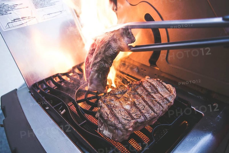 A steak on a gas barbecue in the fire