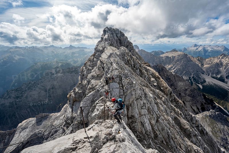 Climber on a via ferrata secured with steel rope