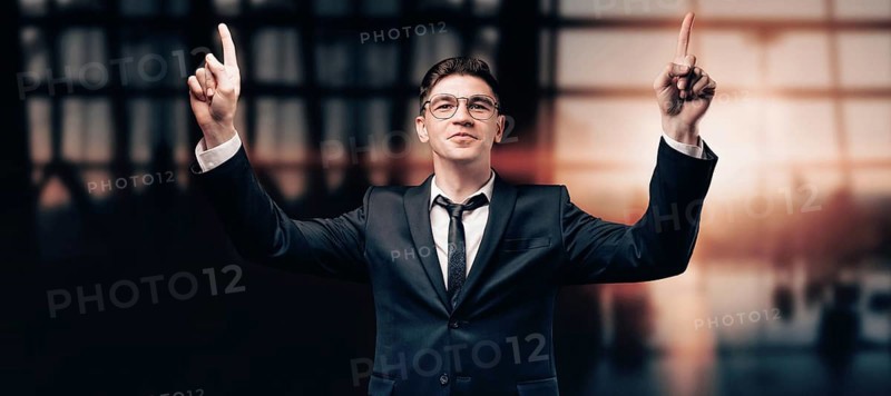 Portrait of a man in a business suit. He is standing at the airport with his hands up. VIP transportation. Private airlines. Charter flights.