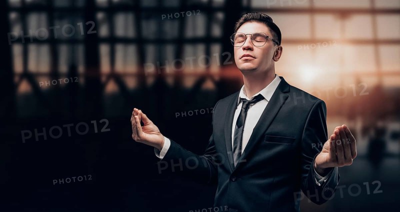 Portrait of a man in a business suit. He is meditating at the airport. VIP transportation. Private airlines. Charter flights.