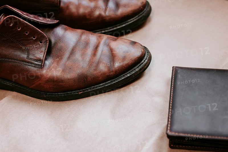 Brown men's shoes made of genuine leather and a brown leather wallet with money
