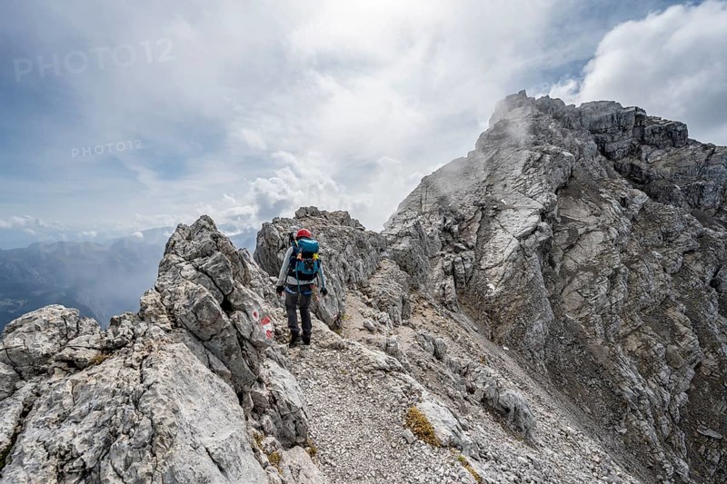 Mountaineer on a narrow rocky ridge