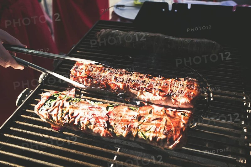 A piece of meat on a gas barbecue