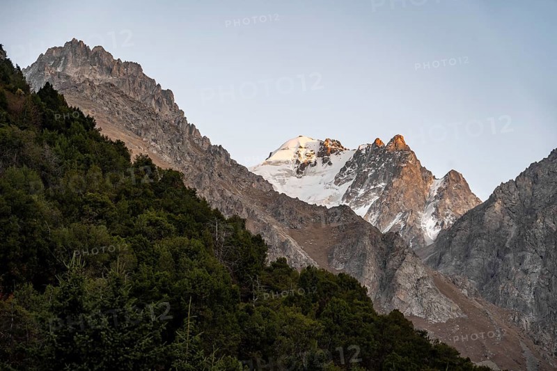 Glaciated mountain peak at sunset