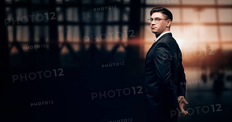Portrait of a man in a business suit. He is standing at the airport and looking at the camera. Airline concept. VIP transportation. Private airlines. Charter flights.