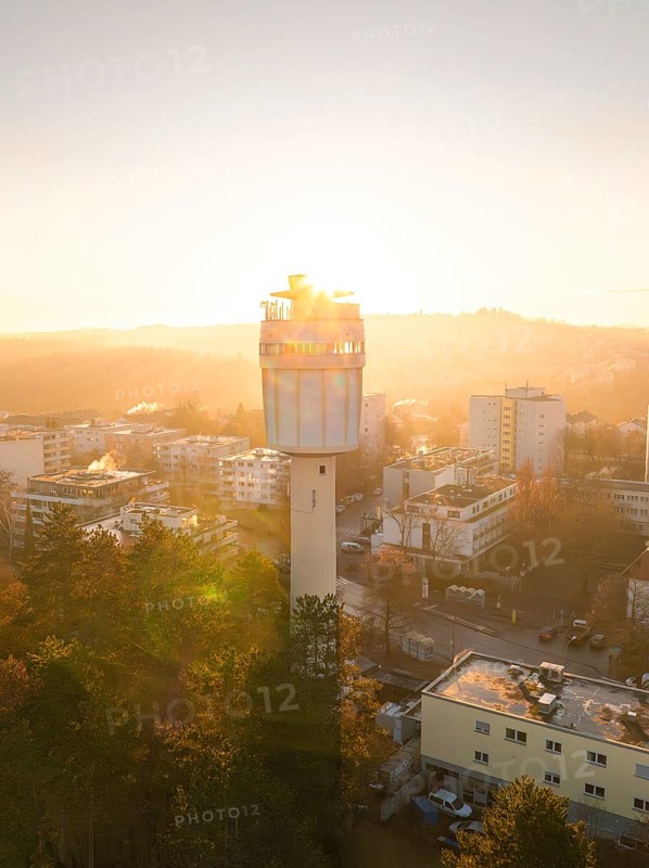 Aerial view A water tower stands in the centre of the city view at dawn