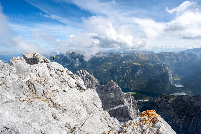 Mountaineer on the steep rocky summit of the Watzmann Mittelspitze