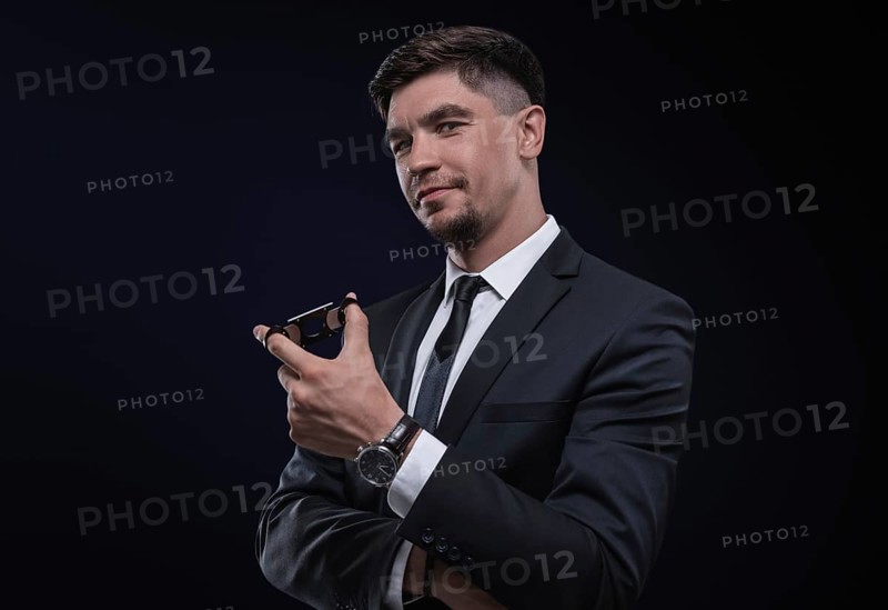 Portrait of a stylish man in a suit with a cigar. Business concept.