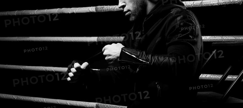 Mixed martial artist wraps bandages around his fist. Concept of mma