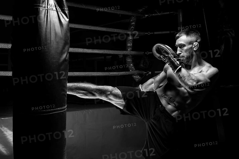 Kickboxer kicks the bag. Training a professional athlete. The concept of mma