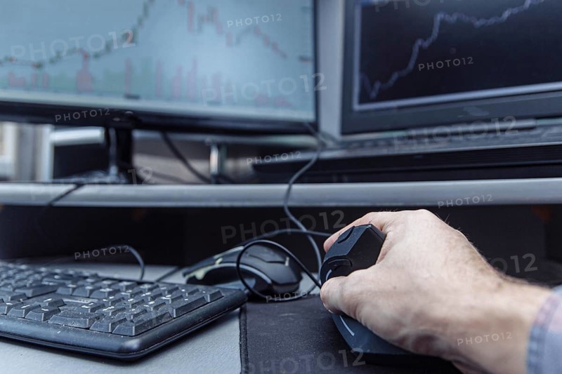 Man's hand uses a vertical ergonomic computer mouse-joystick