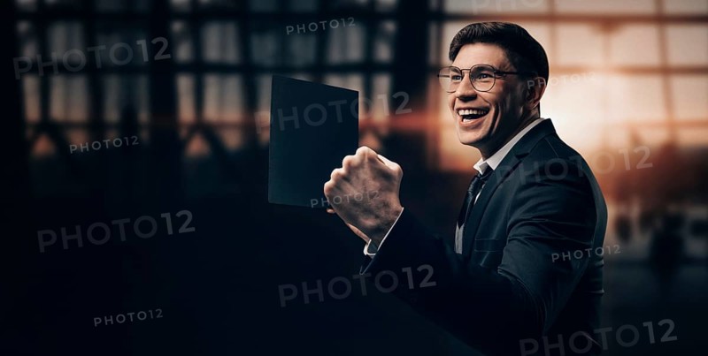 Portrait of a man in a business suit. He is standing at the airport with his hands up. VIP transportation. Private airlines. Charter flights.