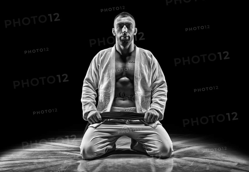 Professional athlete sits in the gym. Concept of karate