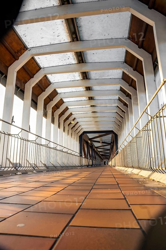 Depth effect in an empty architectural corridor with concrete structure and railings