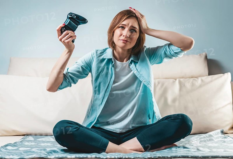 Portrait of a girl with a joystick in her hands. The concept of video games