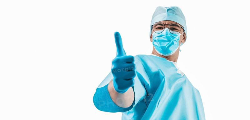 The doctor shows a raised finger up on a white background. Medicine concept.