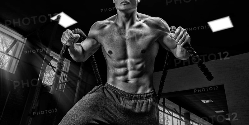 Portrait of an athlete who pulls the ropes. View from below. The concept of sport and healthy lifestyle.