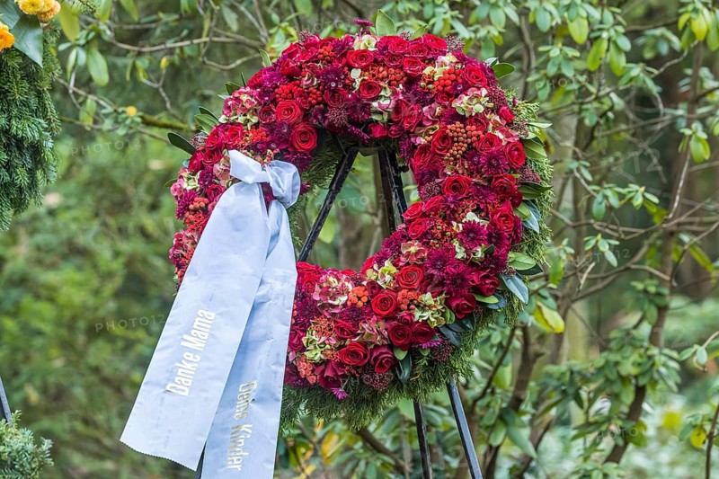Funeral wreath with flowers at a grave