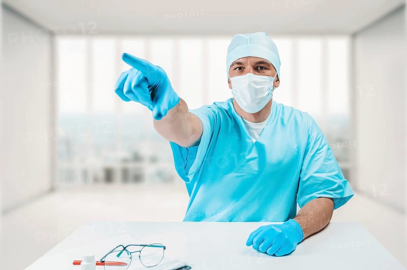 The doctor in the clinic points to an information board. Medicine concept.