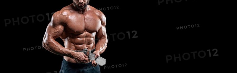 No name sexy muscular man in jeans posing on black background with a belt. Bodybuilding and fitness concept.