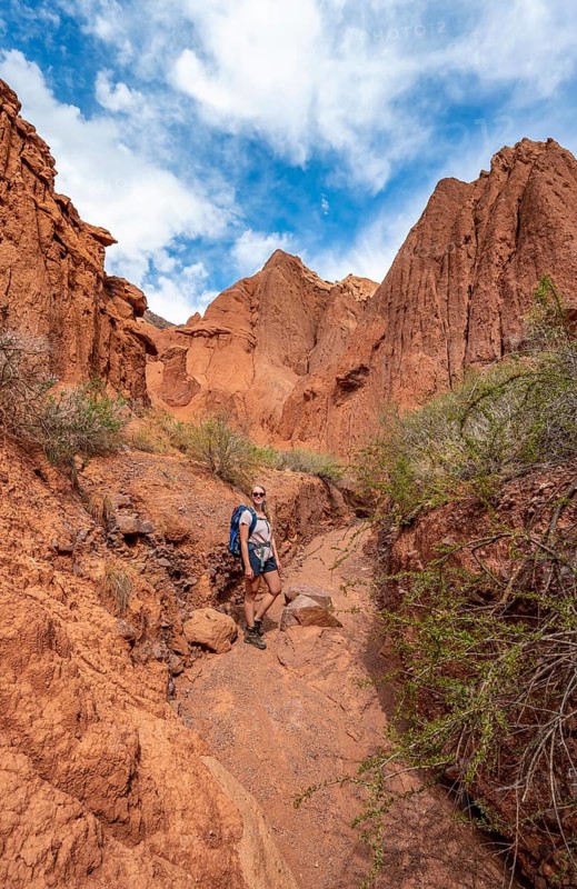 Climber in a canyon with a dry stream bed