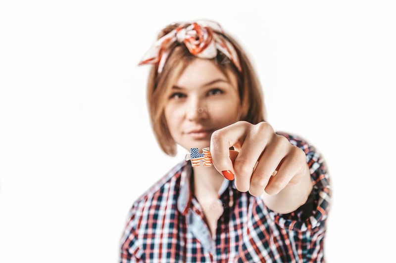 Portrait of a girl holding a puzzle with the USA flag. Concept of emigration