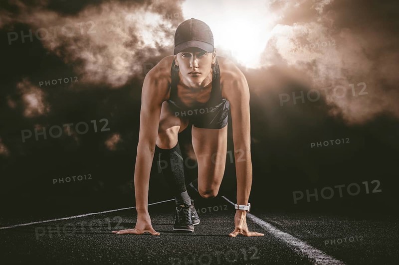 Professional runner stands on the track and prepares for the start of the race. Sports concept.