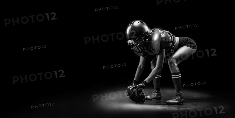 Image of a girl in the uniform of an American football team player. Beginning of the game. Sports concept. Shoulders pads.