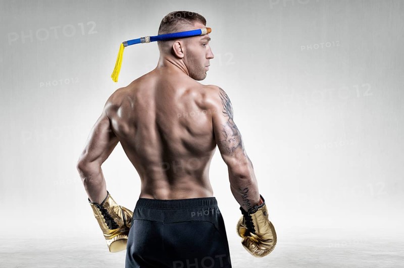 Portrait of a Thai boxer. Back view. Mixed martial arts concept. Competitions and tournaments