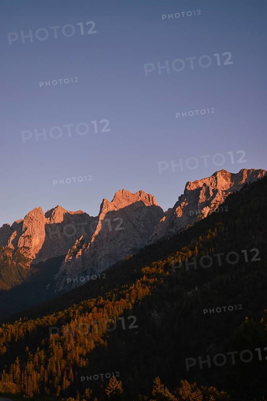 The last rays of sunlight illuminate the peaks of the Wilder Kaiser