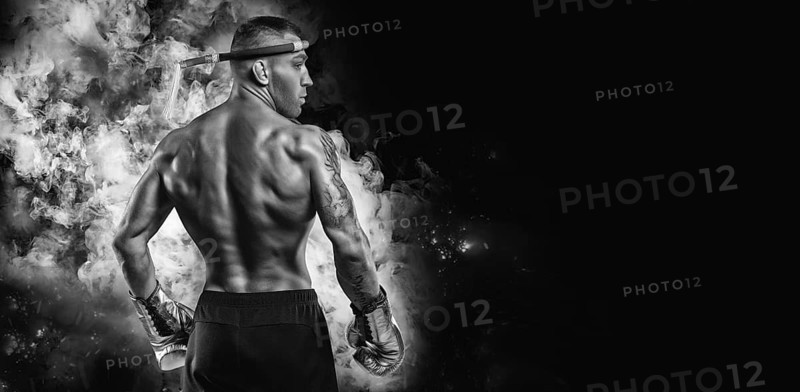 Portrait of a Thai boxer. Back view. Mixed martial arts concept. Competitions and tournaments