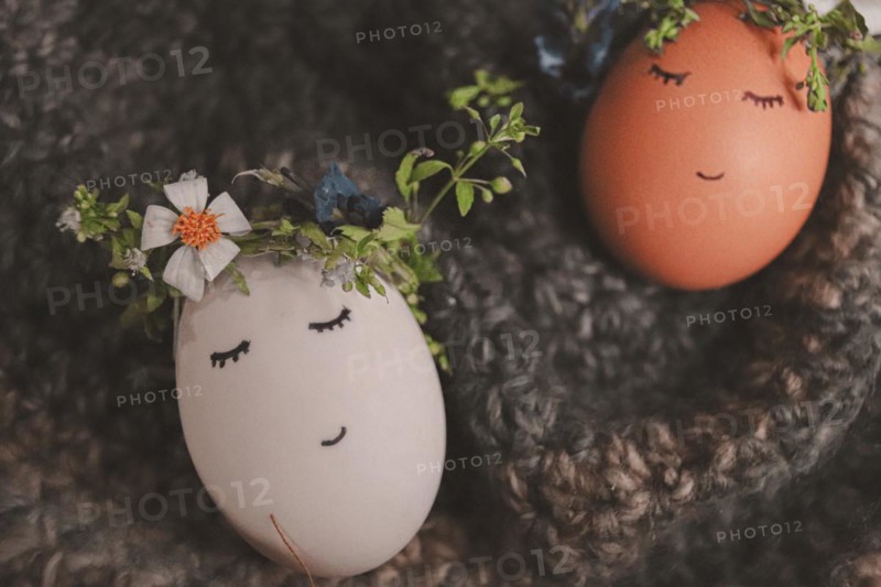 Playful painted eggs with faces and floral decorations