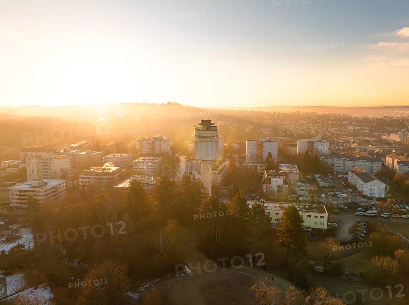 Water tower overlooking the cityscape during a peaceful sunrise