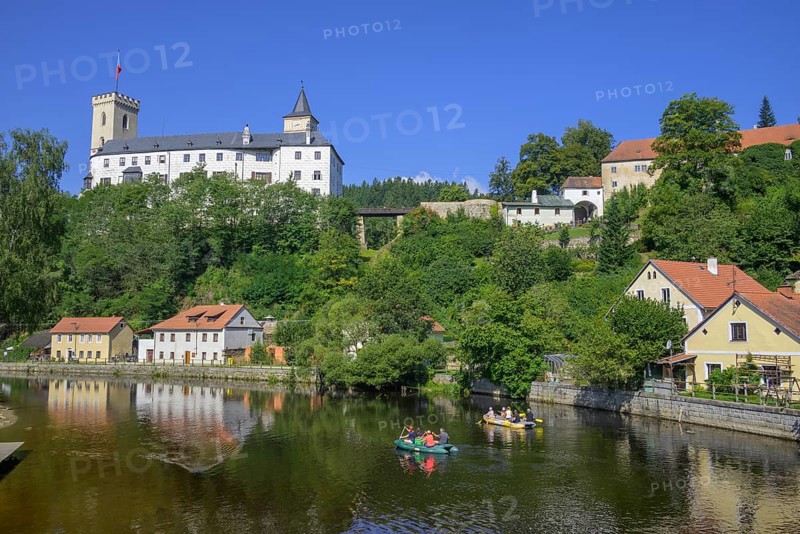 Rubber dinghies navigate the Vltava river behind the castle of