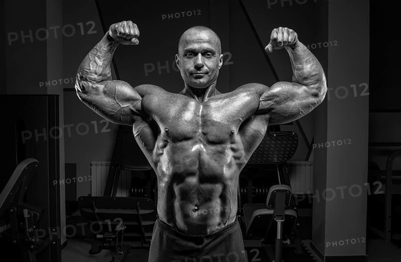 Professional weightlifter posing in the gym. Classic bodybuilding.