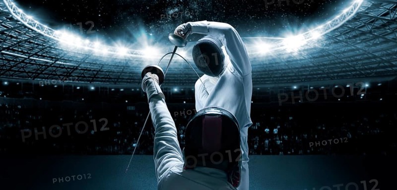Portrait of two fencers against the backdrop of a sports arena. The concept of fencing. Duel.