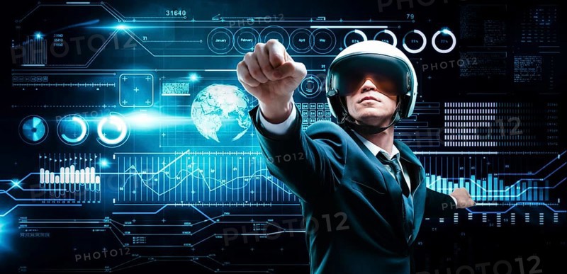 Portrait of a man in a suit and helmet. He shows that he is flying against the background of a hologram of market trading. Business concept. Stock market. Brokers and traders.