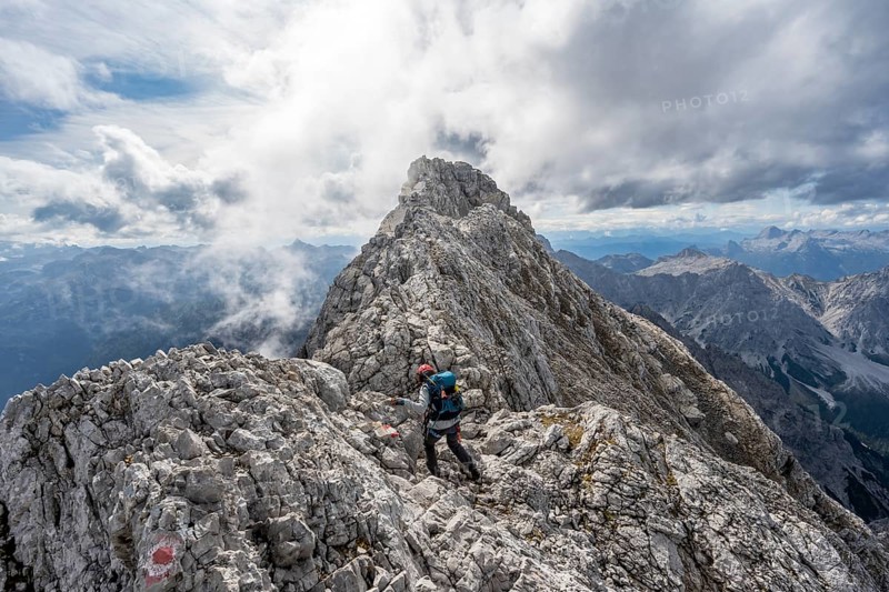 Mountaineer on a narrow rocky ridge