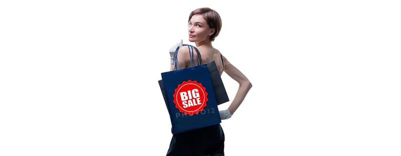 Beautiful young woman in white gloves threw a black craft bag over her shoulder. Shopaholics concept. Spenting. Gifts for the holidays. Black Friday. Shopping centers