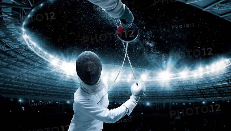 Portrait of two fencers against the backdrop of a sports arena. The concept of fencing. Duel.
