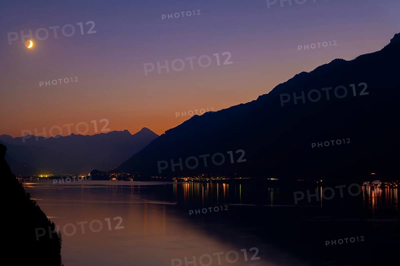 View over Lake Brienz with Mountain and Moon in Twilight in Bernese Oberland