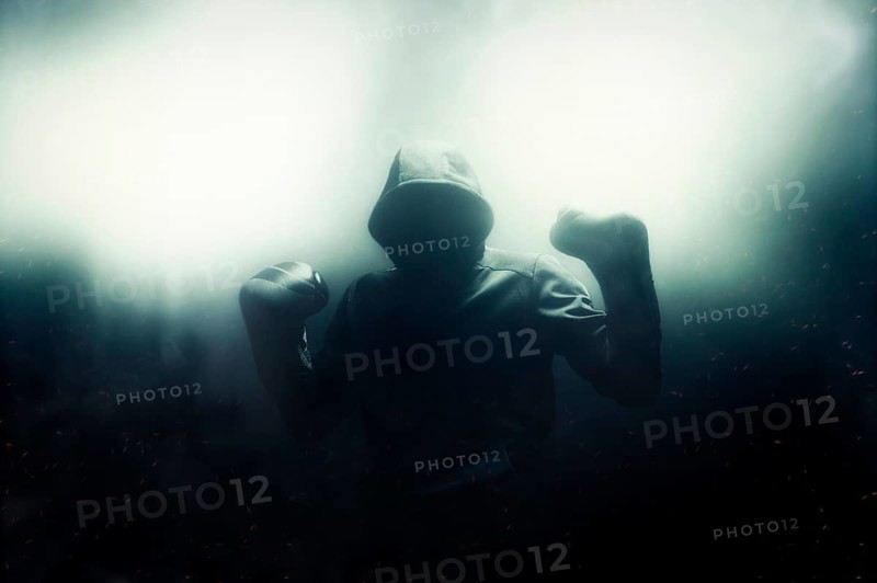 Fighter without a face is standing with his hands up. The concept of boxing