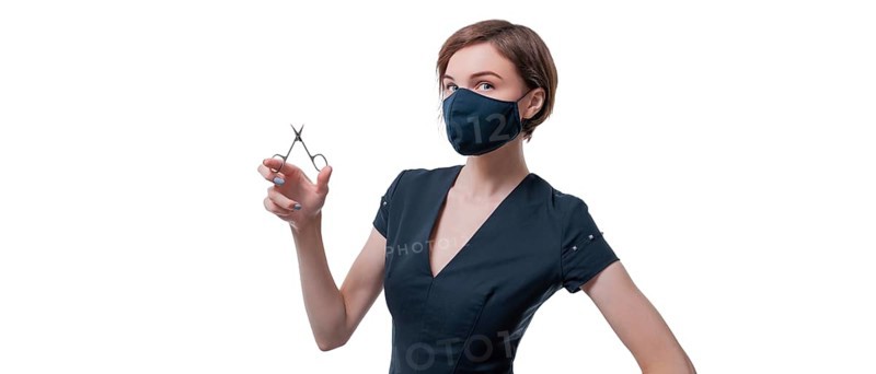 Portrait of an elegant beautiful girl with nail scissors in her hand. Concept of manicure