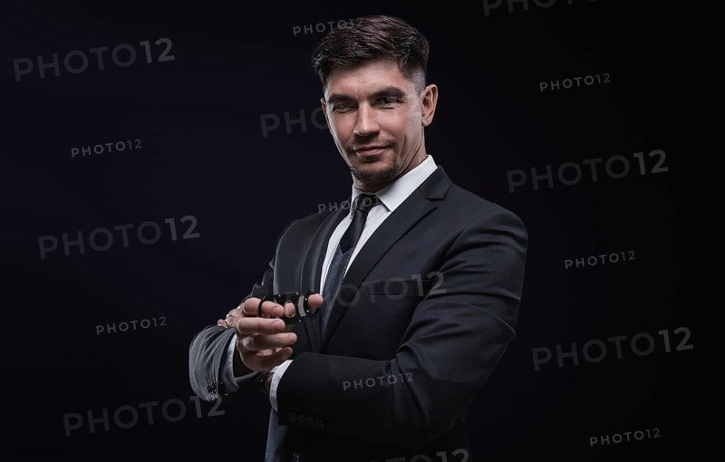 Portrait of a stylish man in a suit with a cigar. Business concept.
