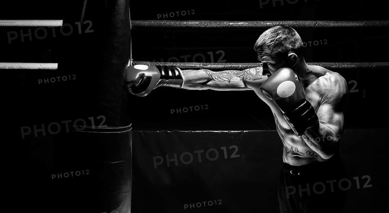 Kickboxer punches the bag. Training a professional athlete. The concept of mma