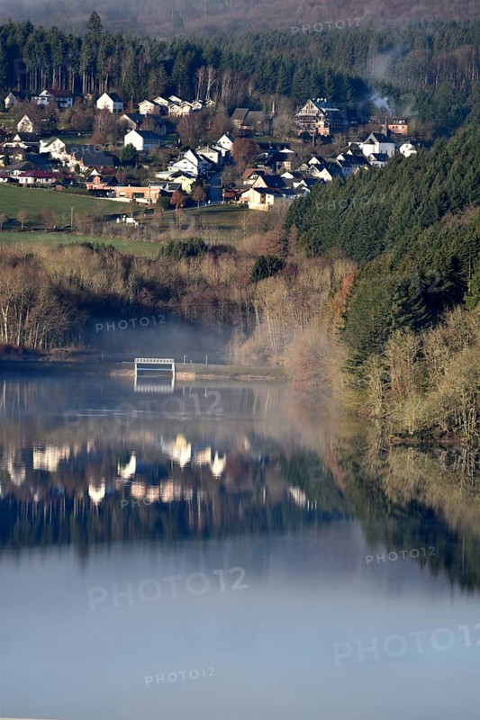 The Steinbach Dam near the national park community of Langweiler on the edge of the Hunsrueck-Hochwald National Park with fog on an early winter morning