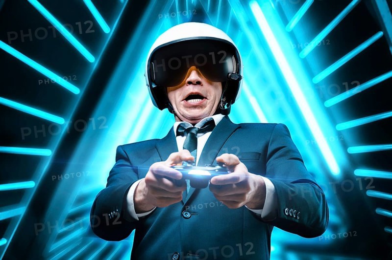 Portrait of a man in a pilot helmet with a joystick in his hands. The concept of gaming tournaments.