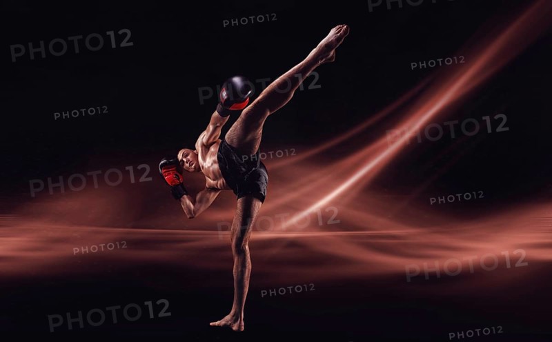 The mma fighter hits a high kick. Kickboxing concept. High quality